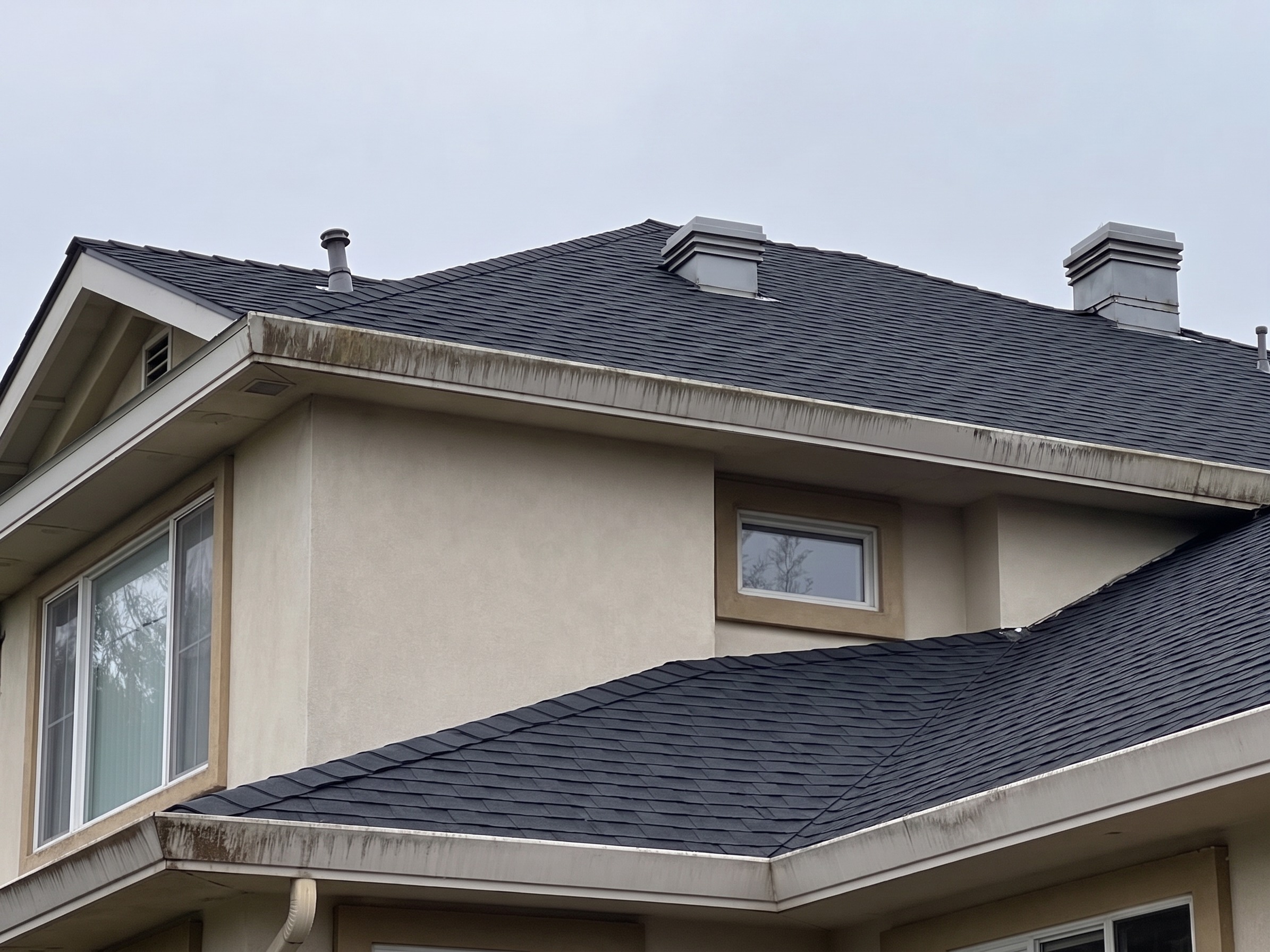 After photo: repaired roof slope with matching shingles and sealed flashing