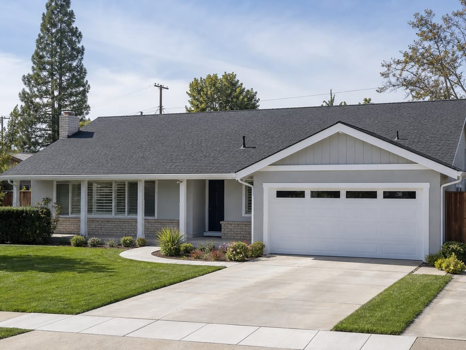 After photo: same home with new charcoal architectural shingles and clean roofline